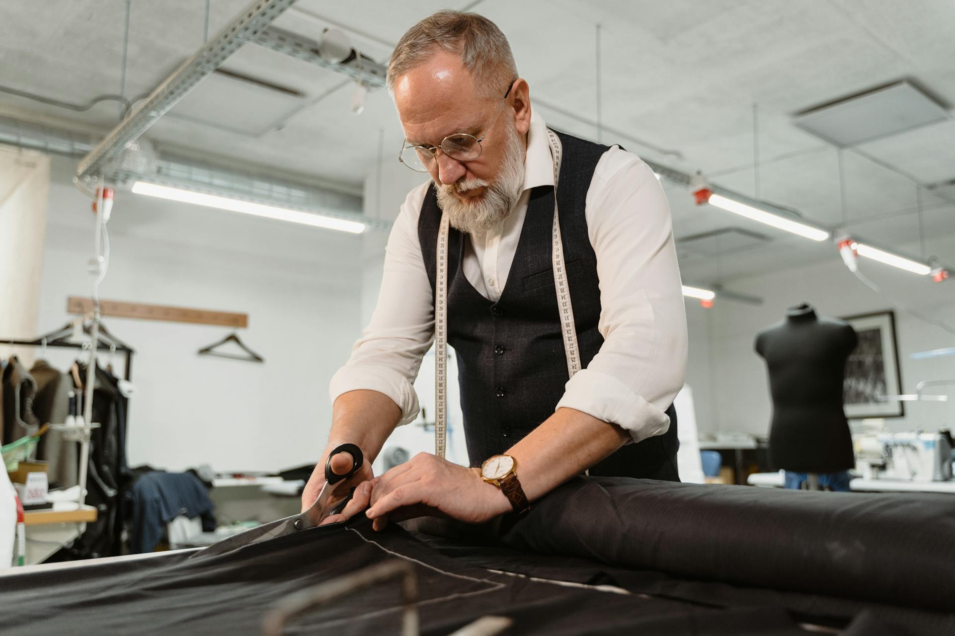 Fine Tailors — precision cutting with vintage shears on dark green wool fabric